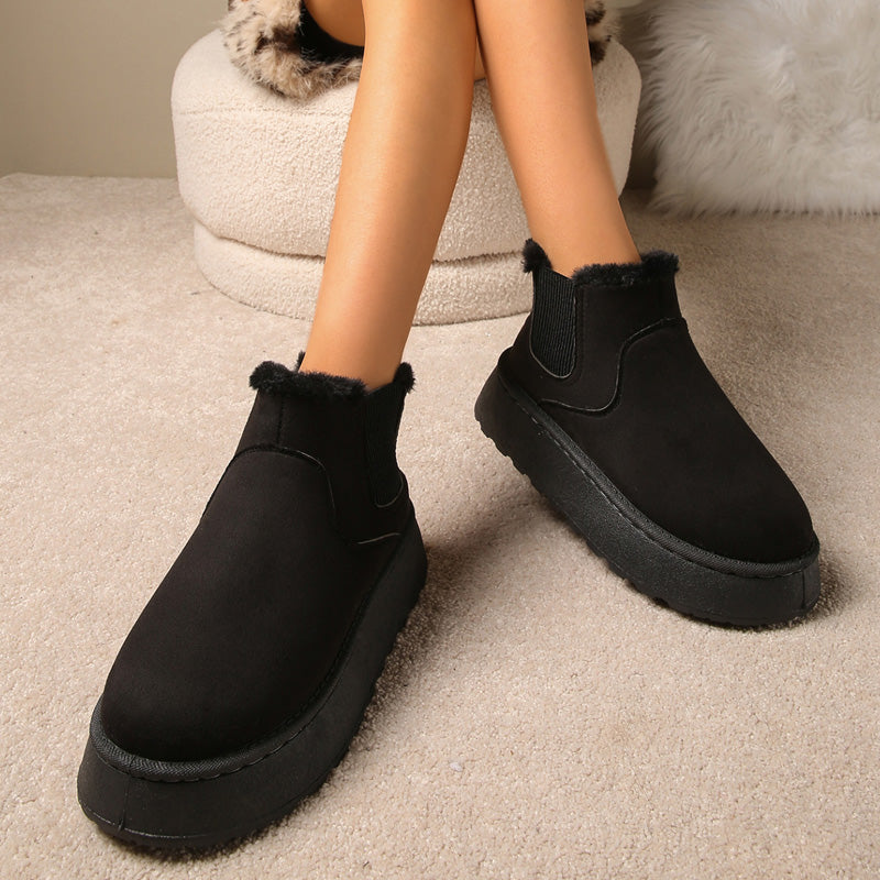 Plush-lined platform ankle boots – black pair worn indoors