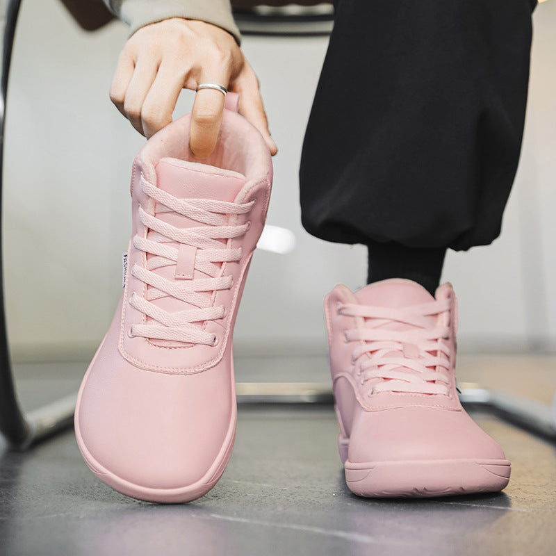 Fleece-lined lace-up winter boots – pink pair being put on