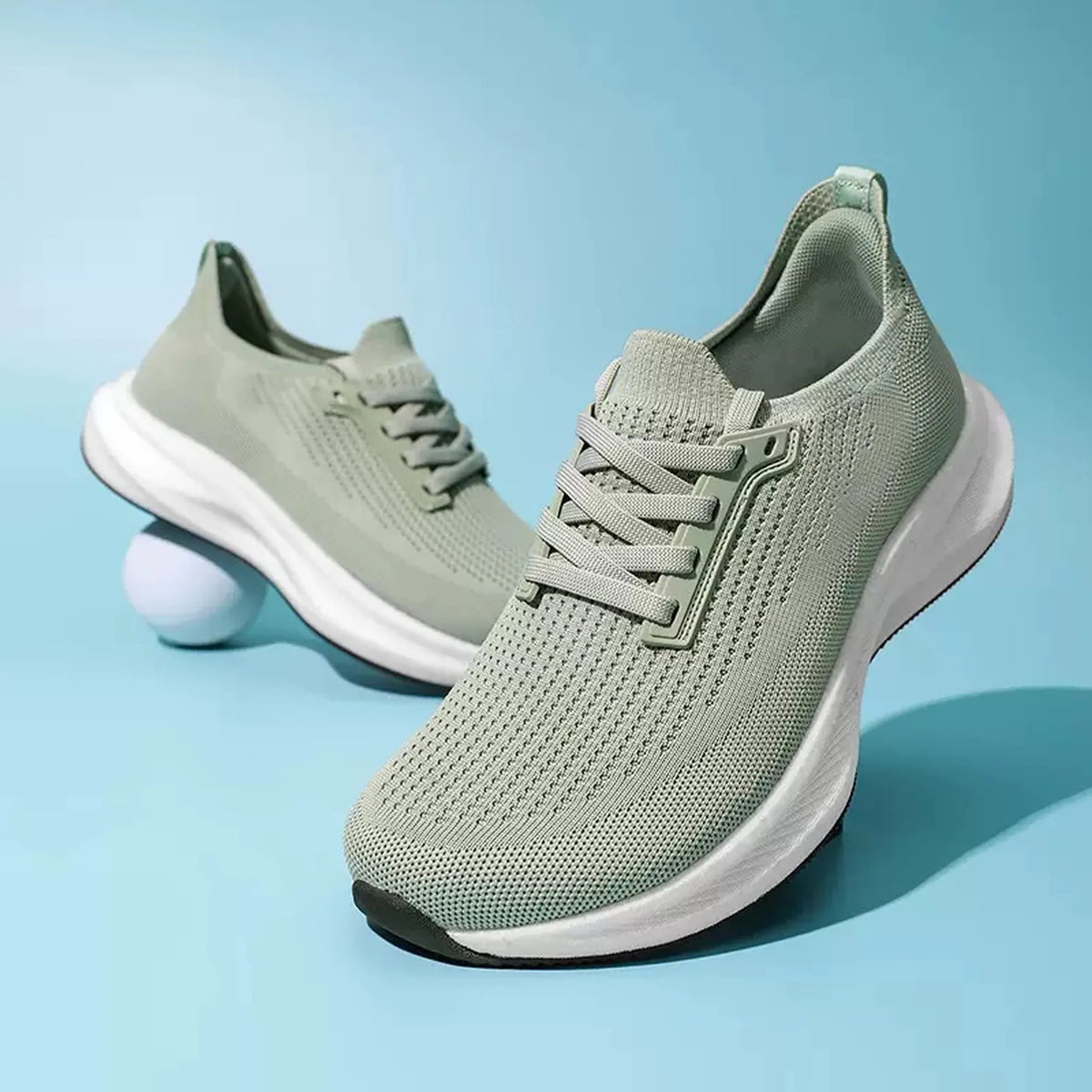 Sage green breathable knit trainers with a sculpted white sole