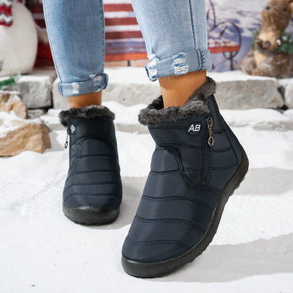Navy blue fleece-lined winter ankle boots worn outdoors