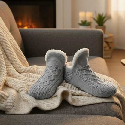 Auldweave unisex soft fleece-lined slipper socks – grey pair beside a fireplace