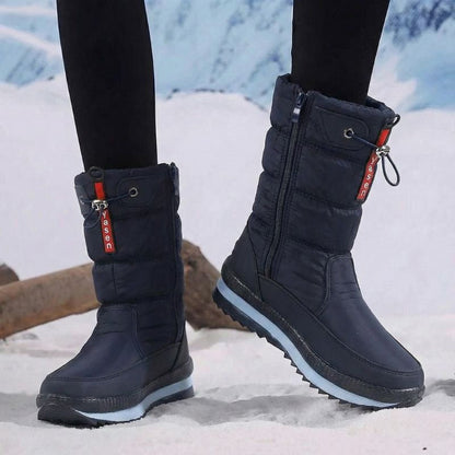 Auldweave women's waterproof mid-calf snow boots – navy pair worn from the front in snow