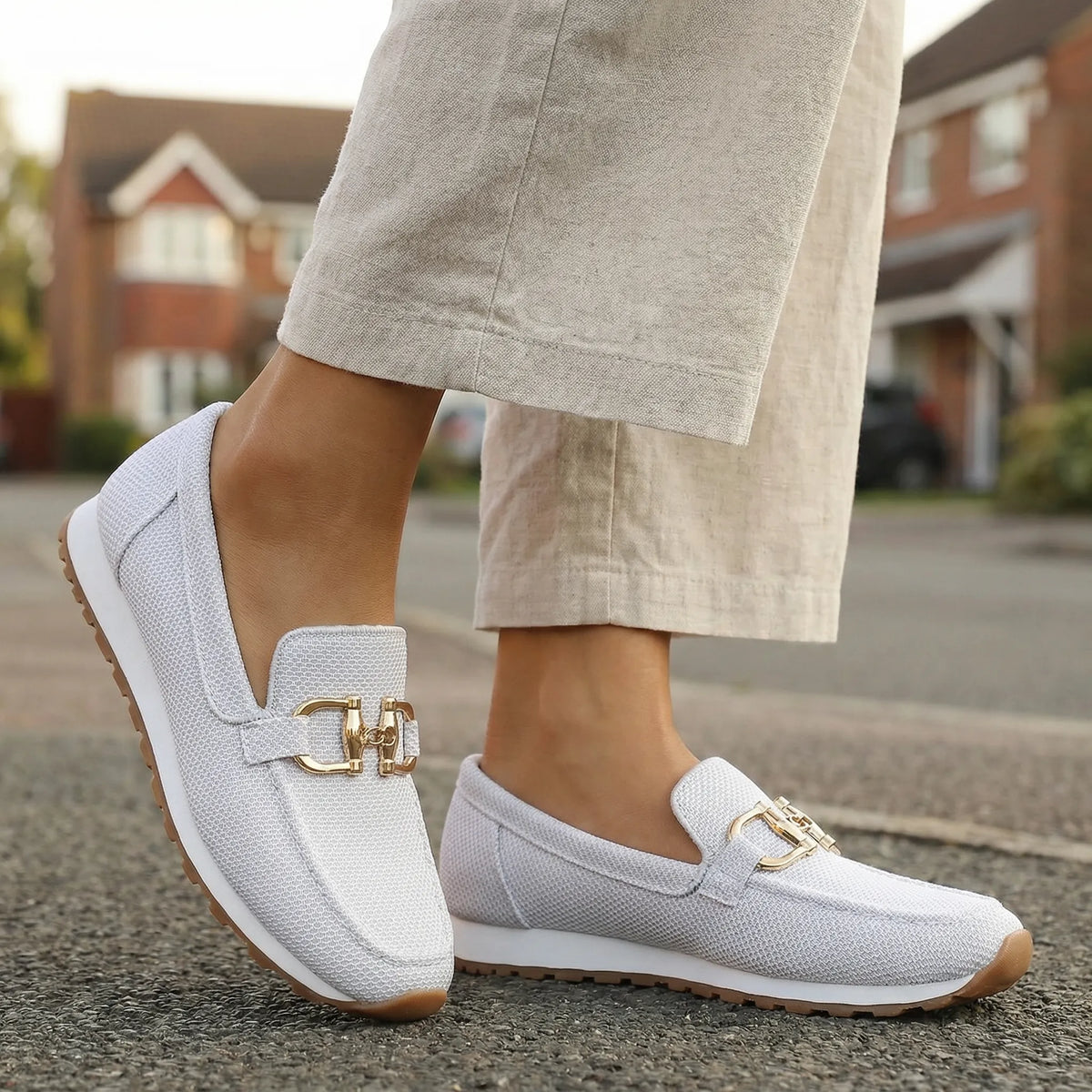 Women's white loafers shown on foot