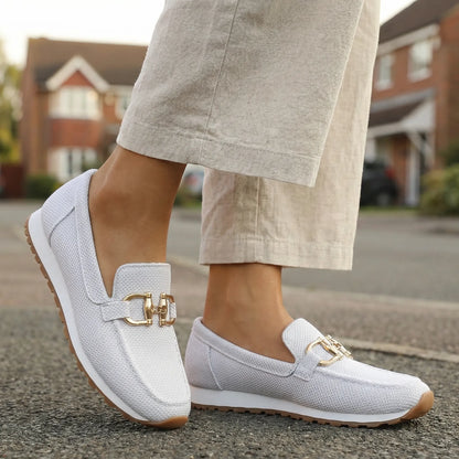 Women's white loafers shown on foot