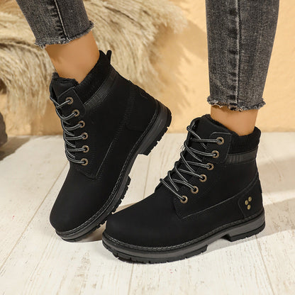 Faux-fur-lined winter ankle boots – black pair worn indoors