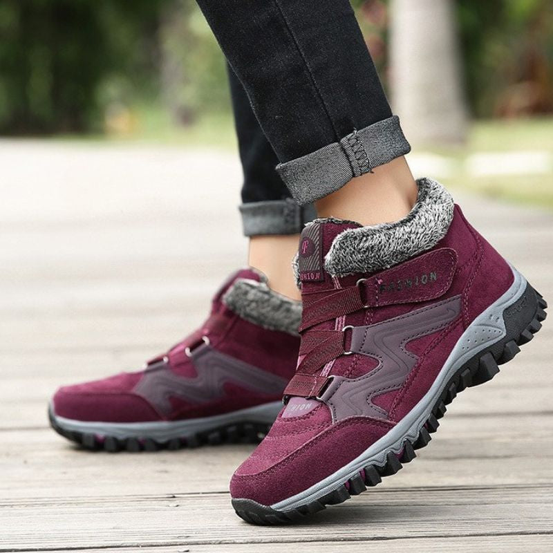 Side view of red winter boots showing the ankle strap