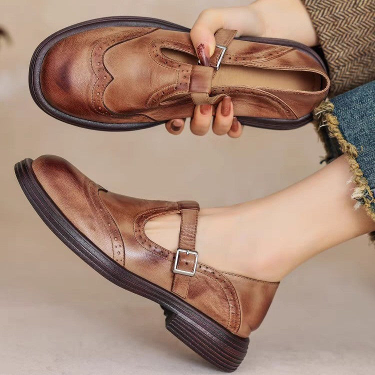 Brown women's Mary Jane brogues showing wingtip detail, lining and low heel