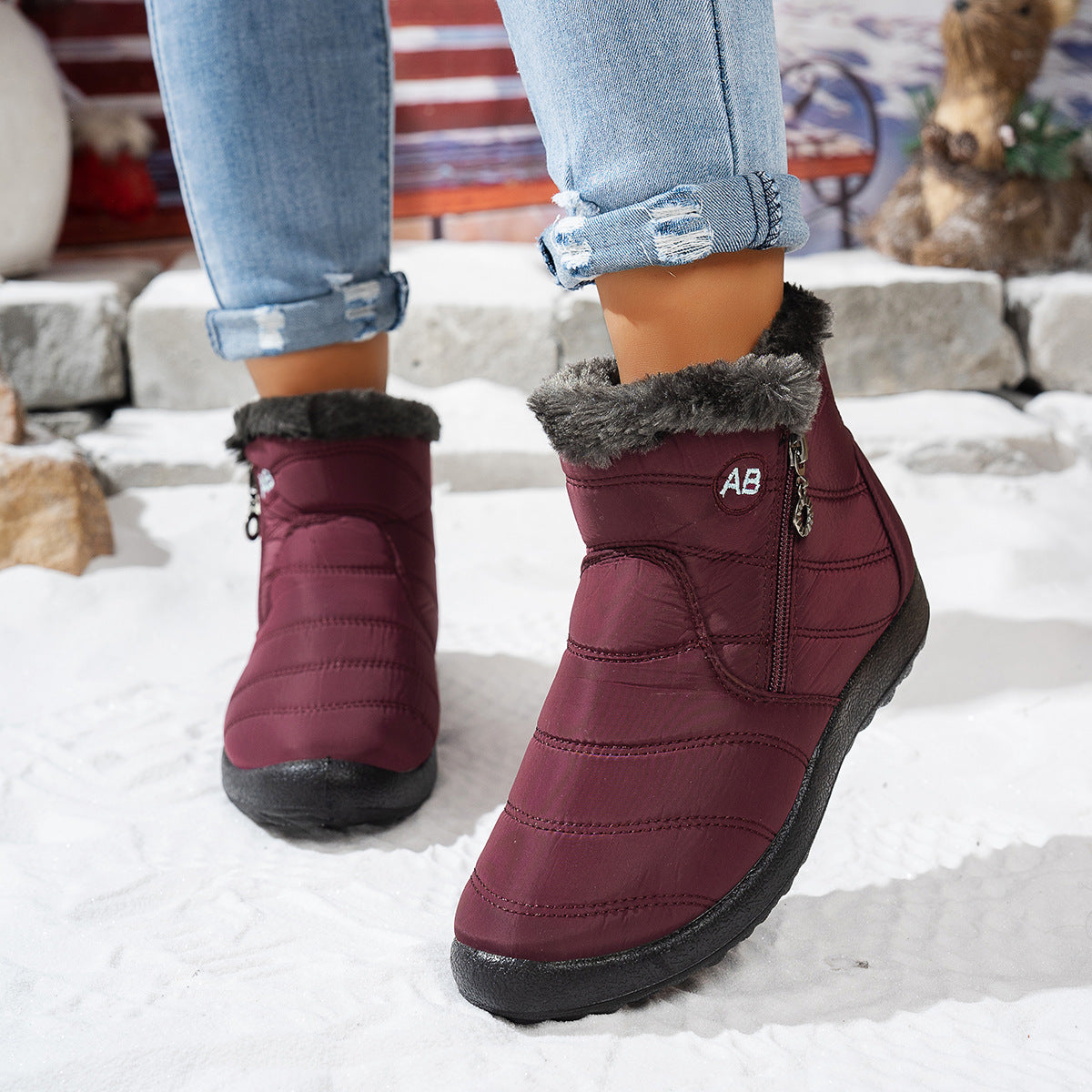 Red fleece-lined winter ankle boots worn outdoors