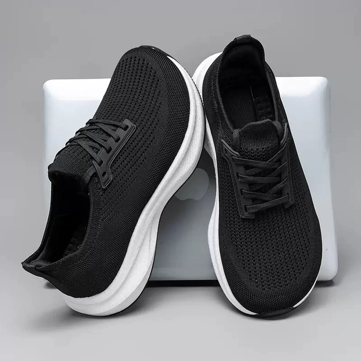 Black wide fit knit trainer with a white cushioned sole
