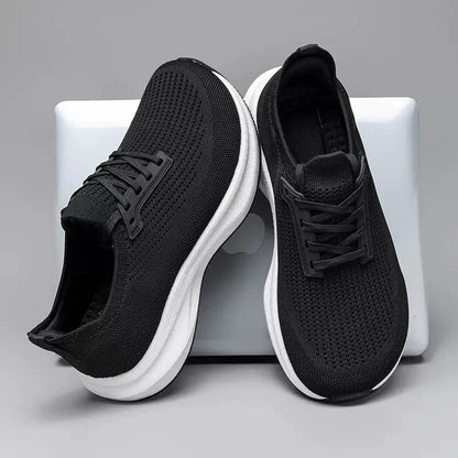 Black wide fit knit trainer with a white cushioned sole