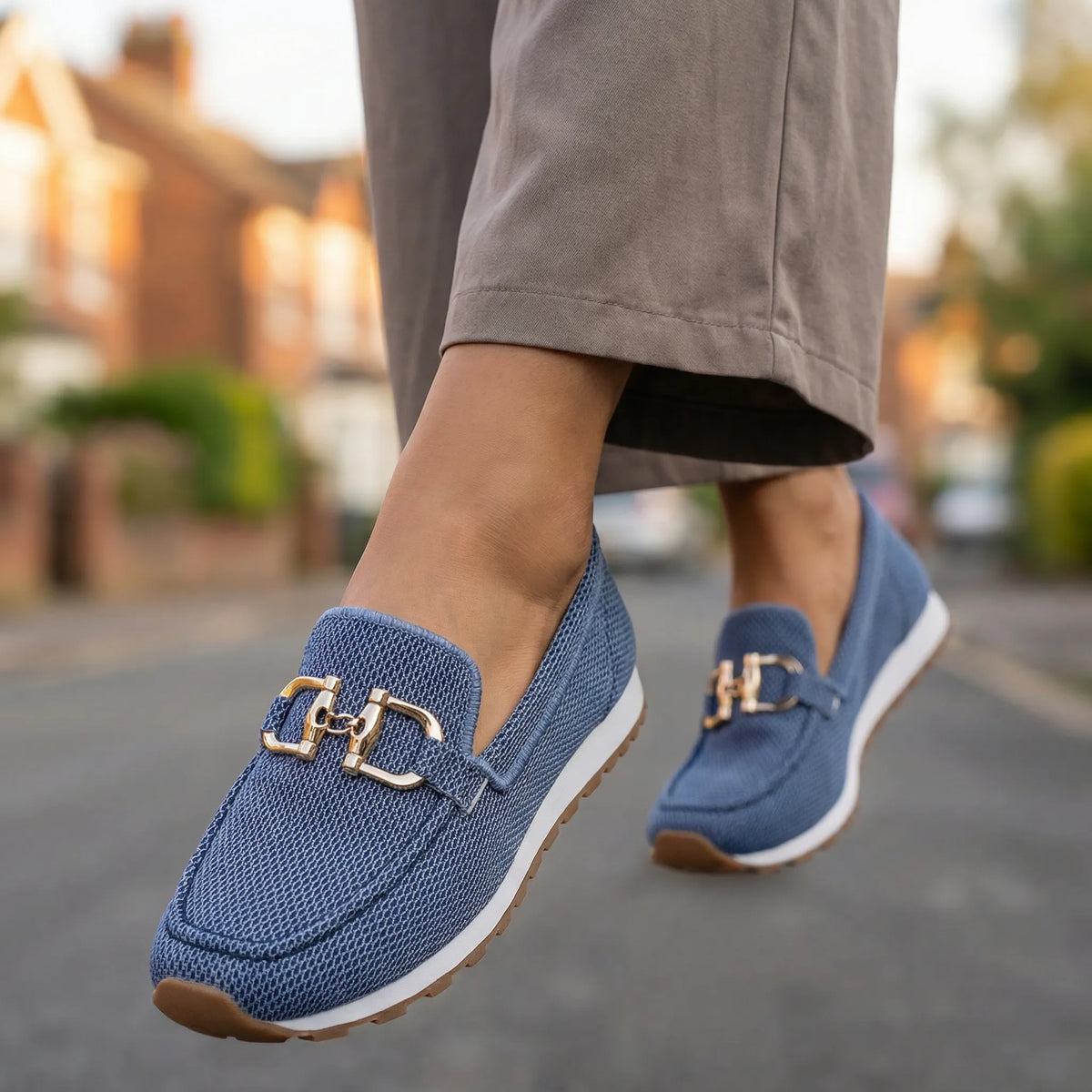 Women's blue loafers shown on foot
