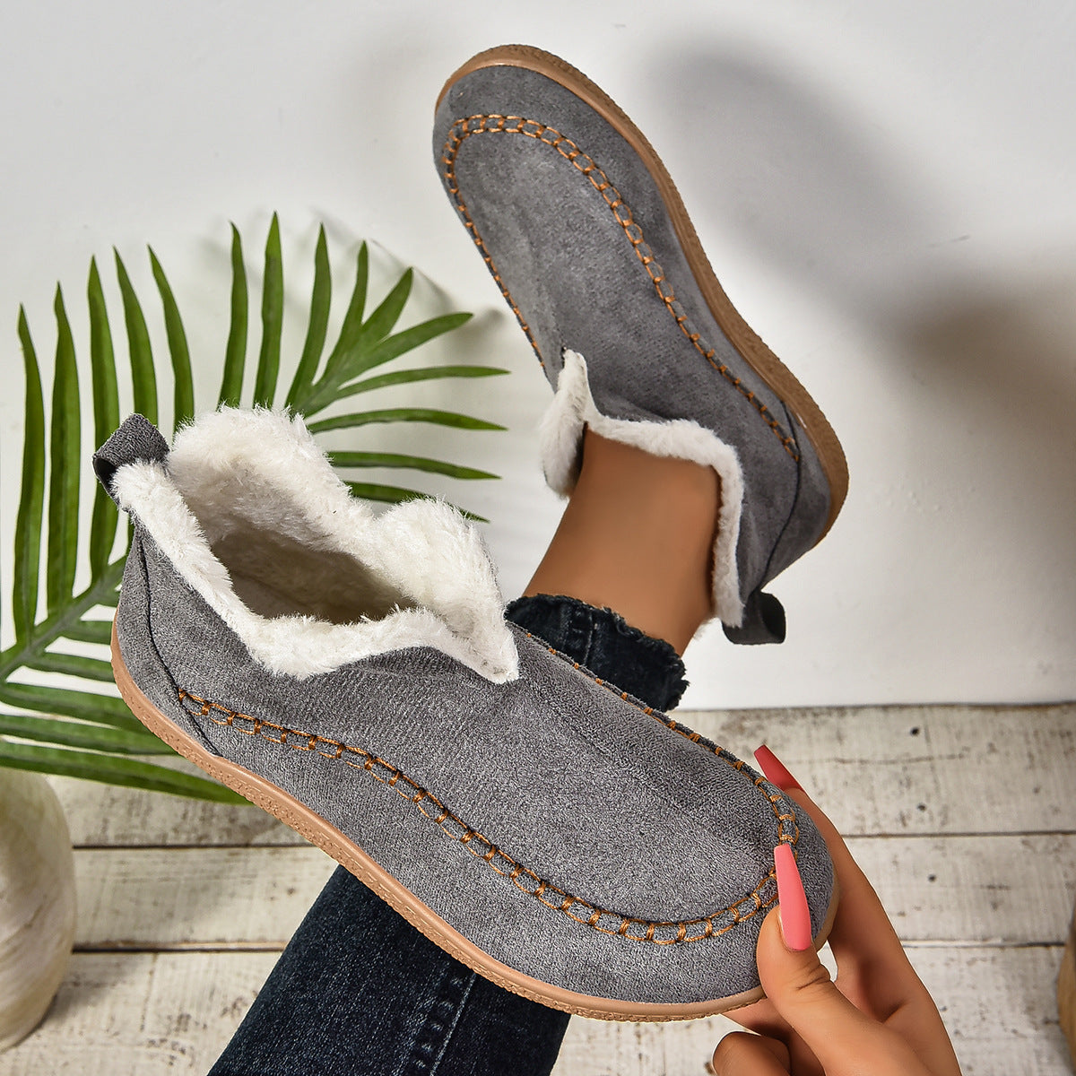 Auldweave women's fleece-lined winter slip-on shoes – grey shoe held to show the lining and sole