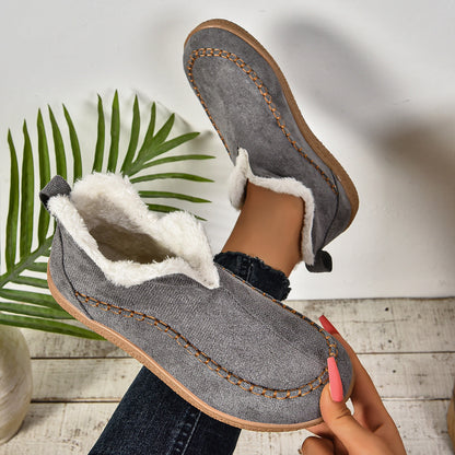 Auldweave women's fleece-lined winter slip-on shoes – grey shoe held to show the lining and sole