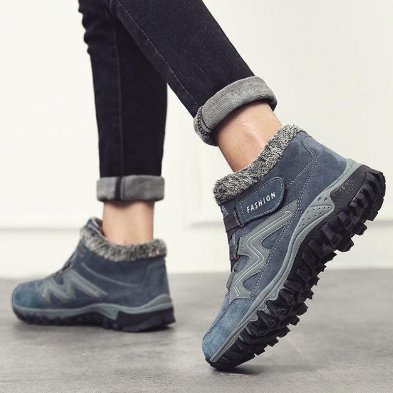 Side view of grey and blue winter boots showing the sole