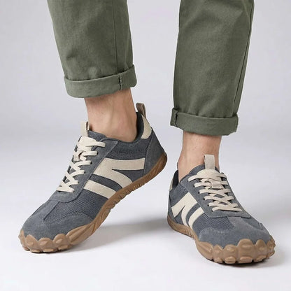 Grey walking trainers shown on foot