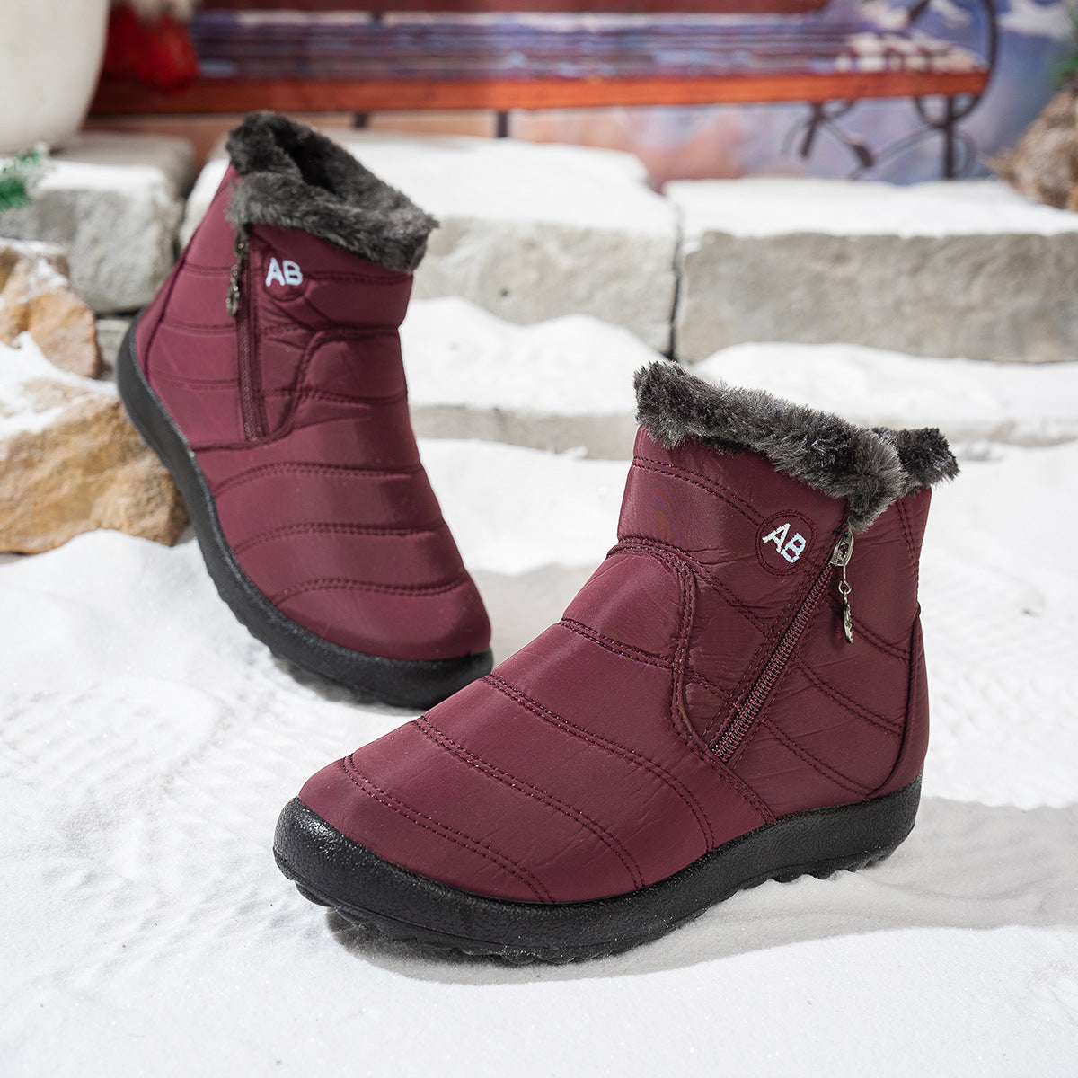 Side view of red winter boots showing the zipper and sole