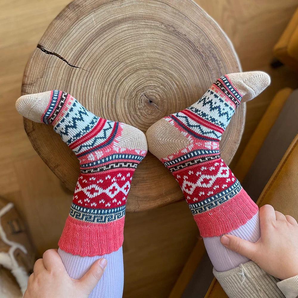 Five-pair Nordic-pattern winter socks – red patterned pair on feet