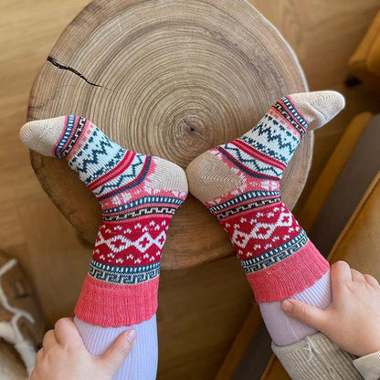 Five-pair Nordic-pattern winter socks – red patterned pair on feet
