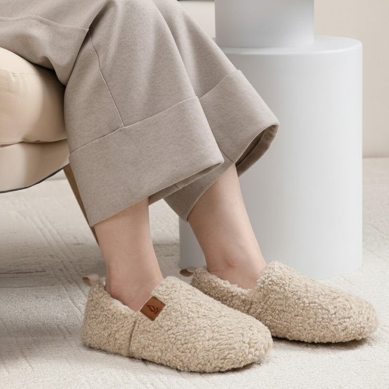 Auldweave women's warm shearling slippers – cream slippers worn in a seated view