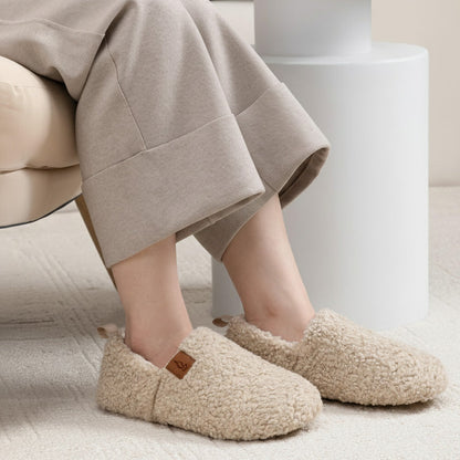 Auldweave women's warm shearling slippers – cream slippers worn in a seated view