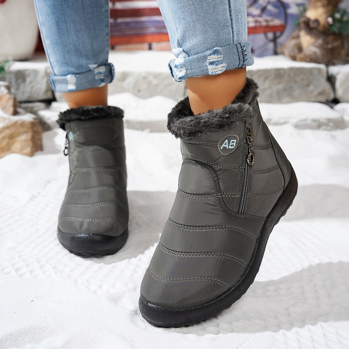Grey quilted winter ankle boots worn outdoors