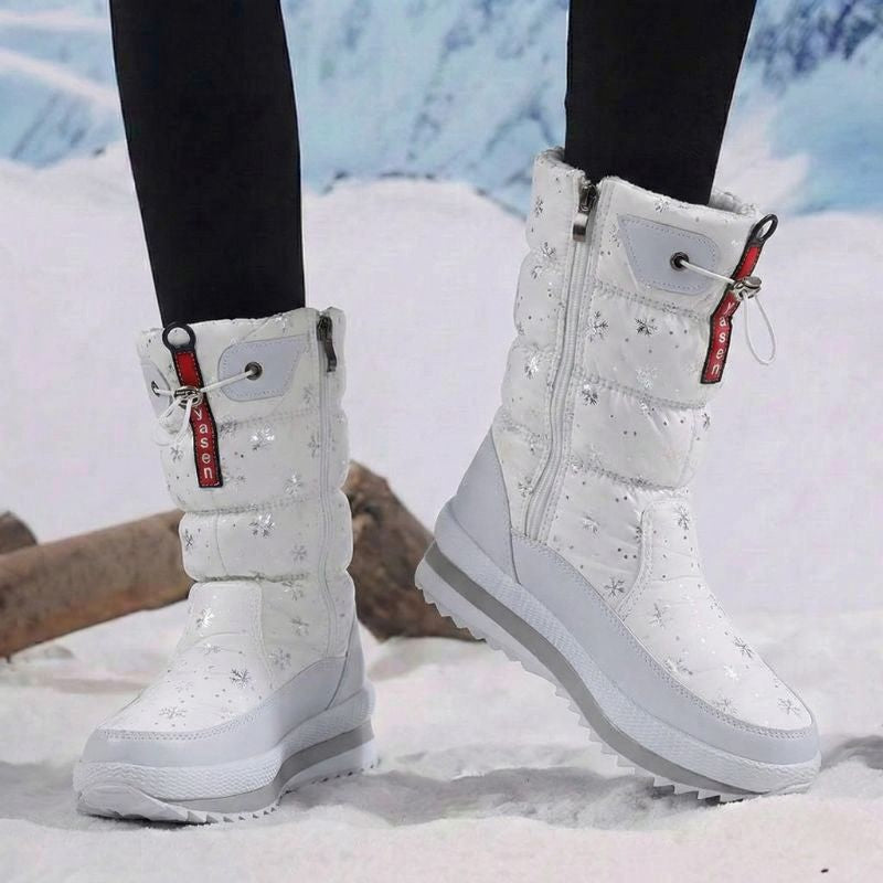 Auldweave women's waterproof mid-calf snow boots – white snowflake boots worn from the side in snow
