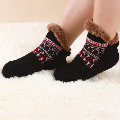 Auldweave warm fleece-lined slipper socks – black pair worn on a soft rug