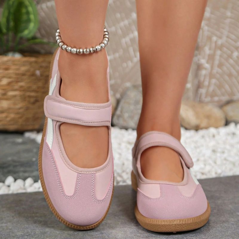 Pink women's Mary Jane trainers with gum soles, front view on feet