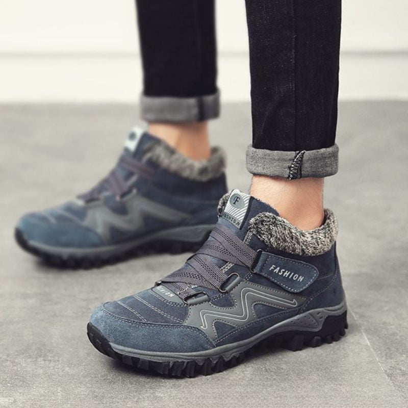 Grey and blue fleece-lined winter boots worn outdoors