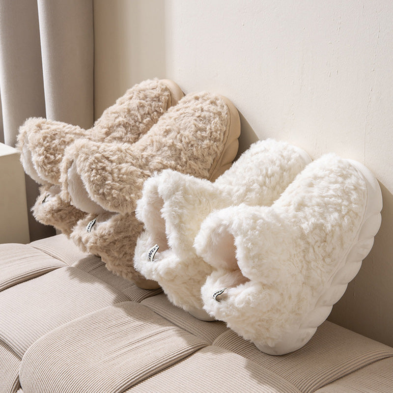 Plush fleece ankle slippers – cream and brown pairs on a sofa