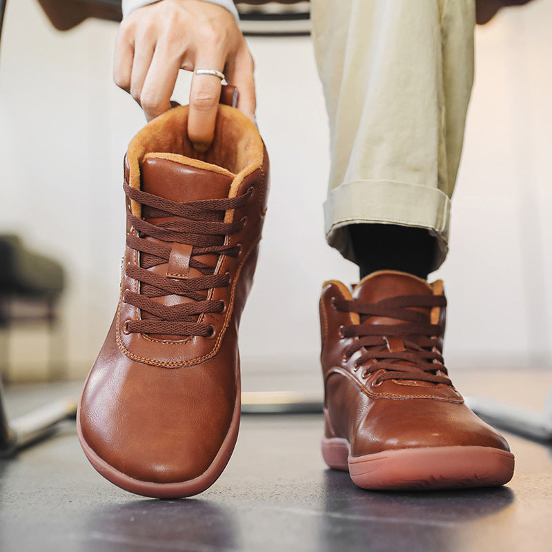 Fleece-lined lace-up winter boots – brown pair being put on