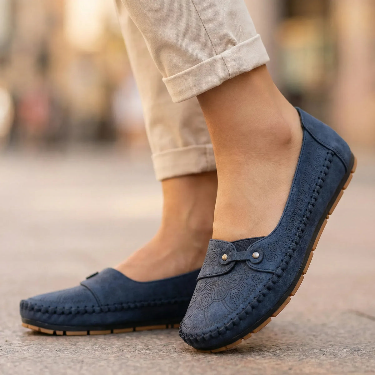 Women's navy loafers shown on foot