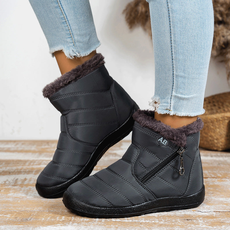 Grey winter boots showing the side zipper and textured sole