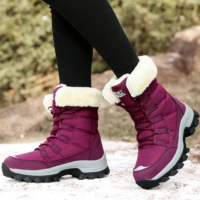 Side view of red winter boots showing the sole and fleece-lined cuff