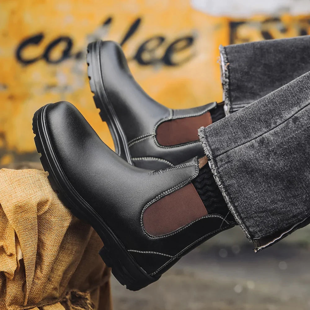 Black Chelsea boots worn with grey jeans in a café setting