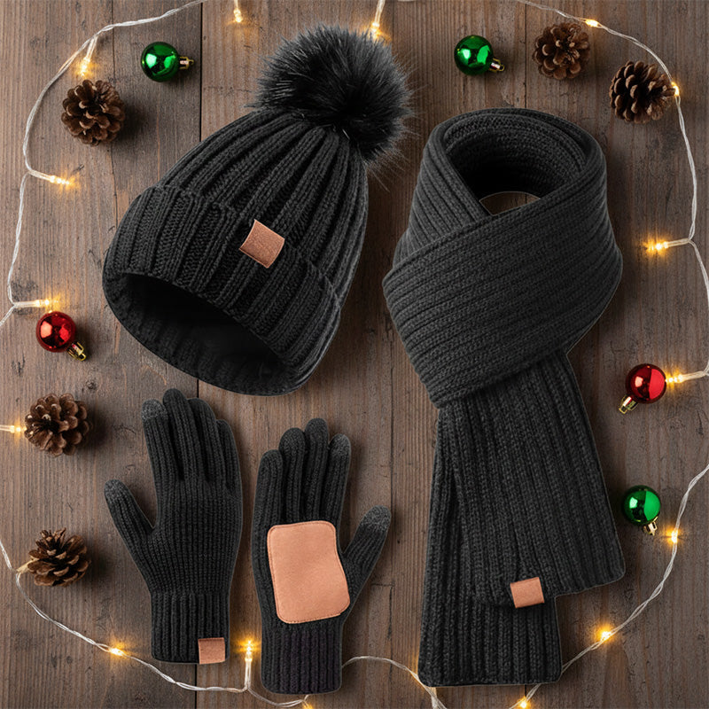 Winter hat scarf and glove set – black set beside festive lights