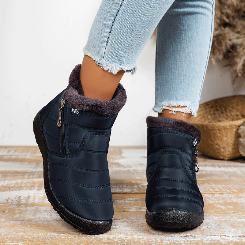 Navy blue winter boots showing the quilted upper and fleece collar