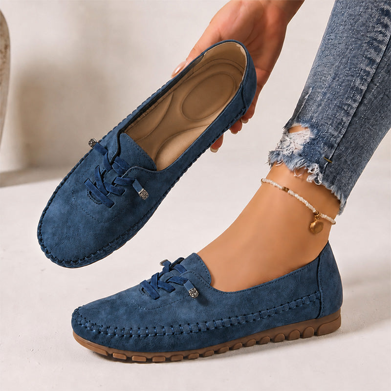 Navy women's suede loafers showing the shaped insole and decorative lacing