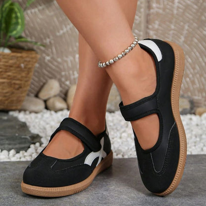 Black women's Mary Jane trainers with gum soles, front view on feet