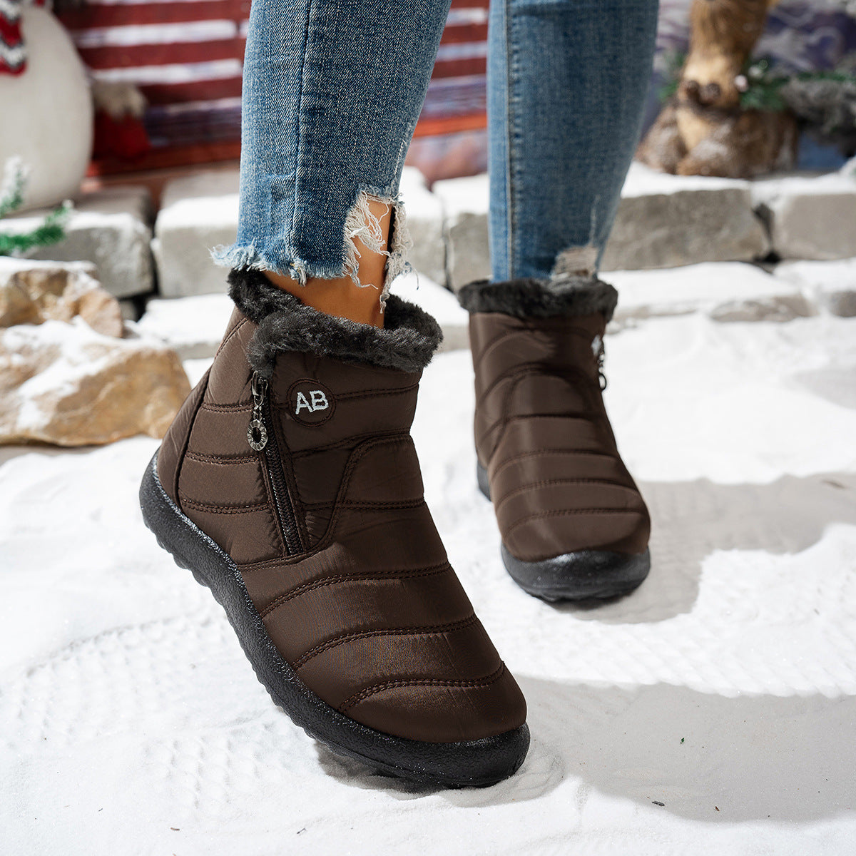 Brown quilted winter ankle boots worn outdoors