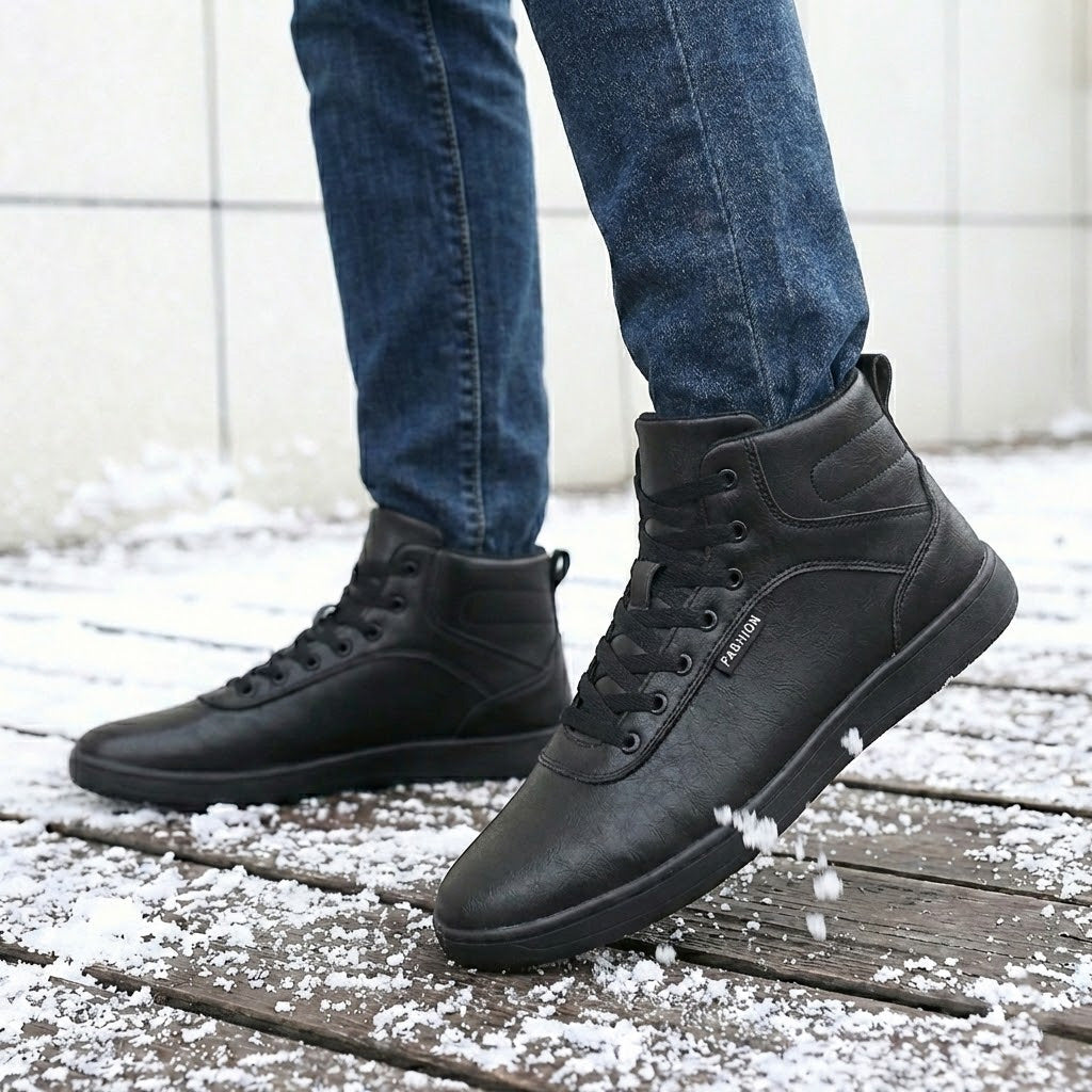 Fleece-lined lace-up winter boots – black pair on a snowy path