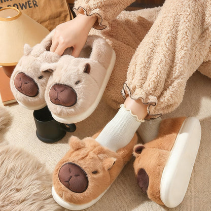 Auldweave women's fluffy capybara slippers – brown and cream pairs held indoors