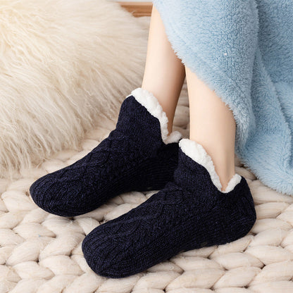 Auldweave unisex soft fleece-lined slipper socks – black pair worn on a soft rug