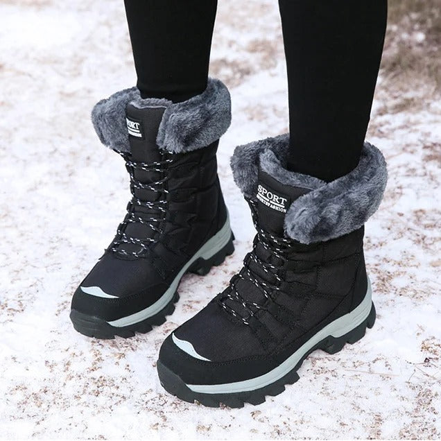 Black winter boots shown from the front while worn in snow