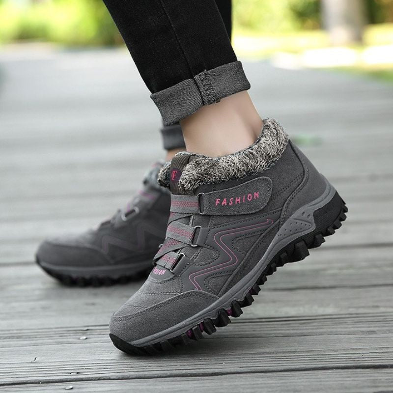 Side view of grey and pink winter boots with ankle straps