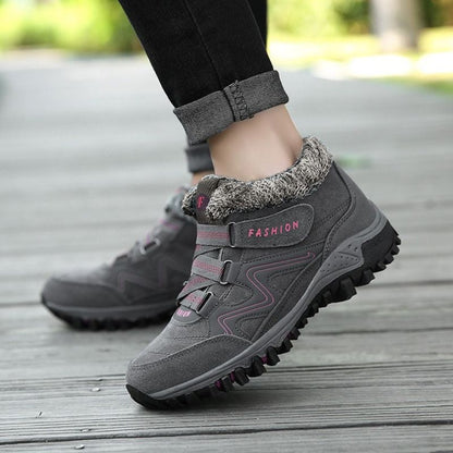 Side view of grey and pink winter boots with ankle straps