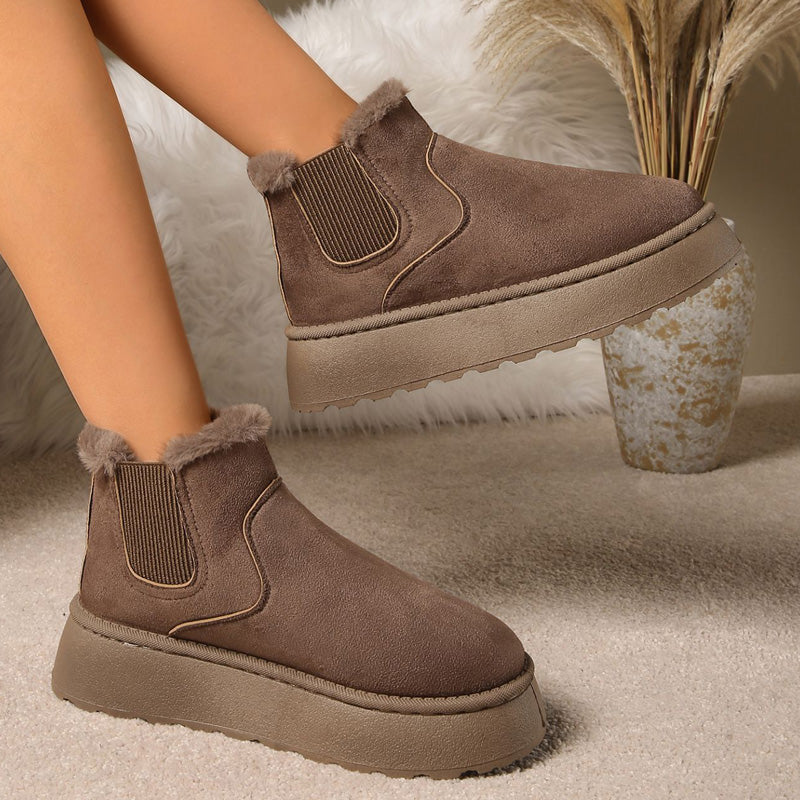Plush-lined platform ankle boots – brown pair worn indoors