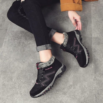 Black and pink winter boots worn with black trousers
