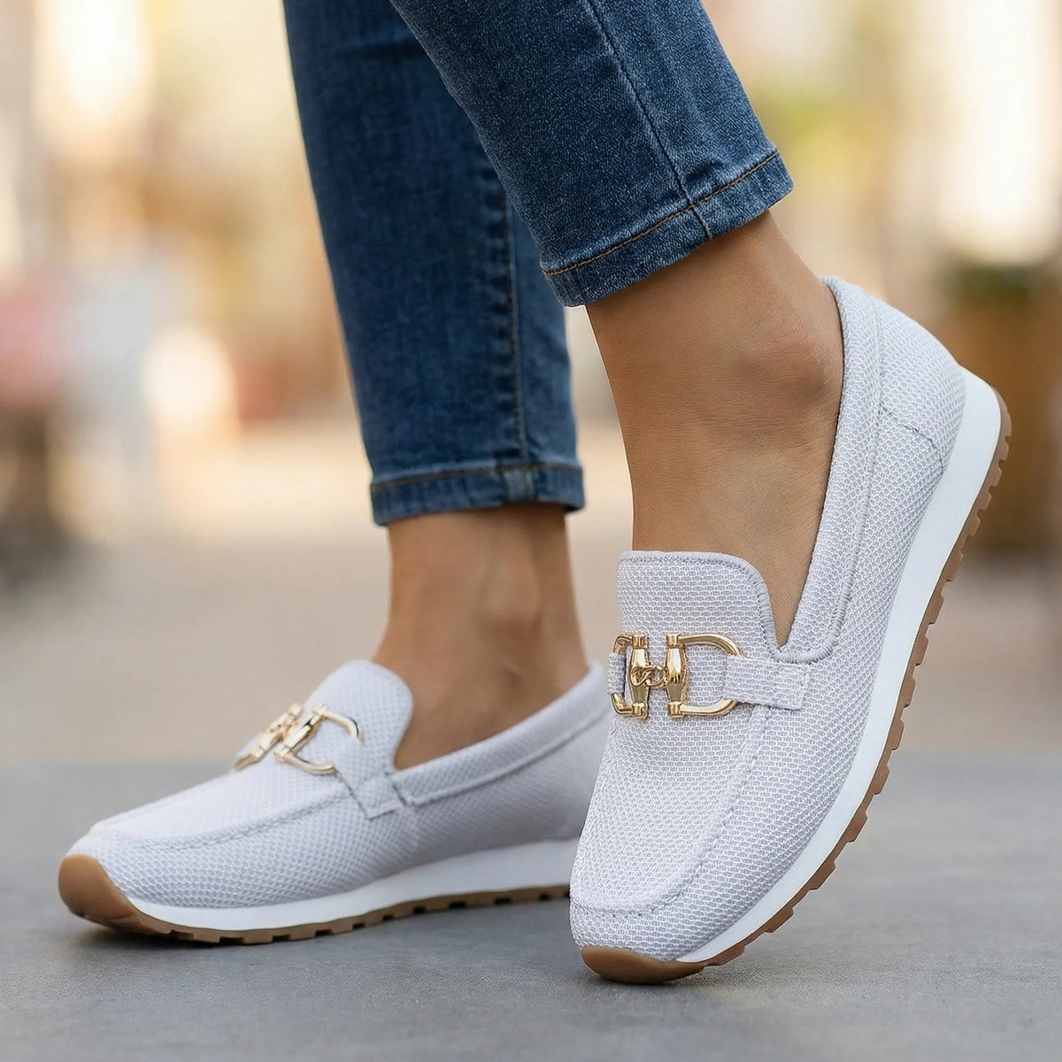 Women's white loafers shown on foot