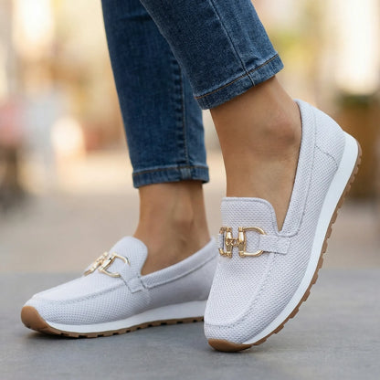Women's white loafers shown on foot